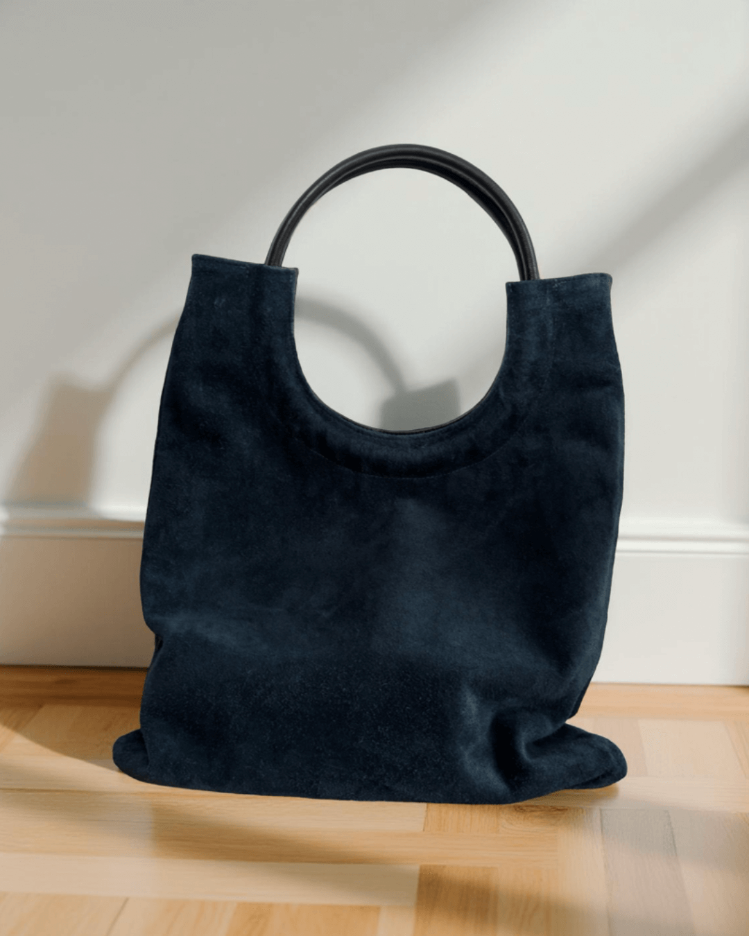 Mixed Emotions Reversible Tote in navy suede, showcasing stylish versatility and practicality for your everyday needs.