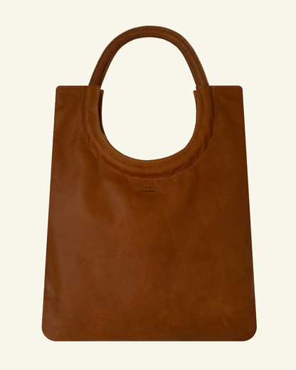 Mixed Emotions Reversible Tote in tan, handcrafted from suede and full-grain leather, perfect for versatile style.